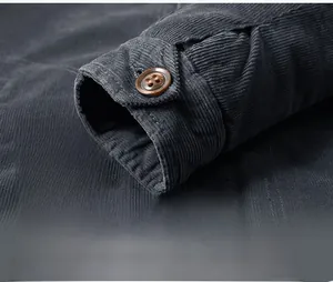Detailed macro view of dark grey corduroy cuff featuring premium stitching and a brown button