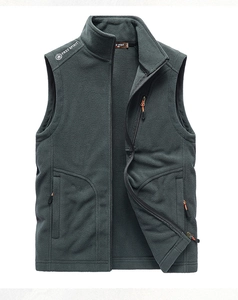 Detailed view of the dark grey fleece vest featuring a stand collar and vertical chest pocket