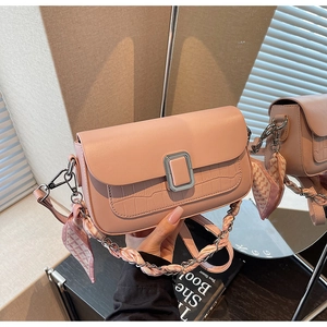 Pink crossbody bag detail showing faux crocodile texture and silk scarf chain strap