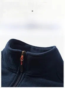 Detail of navy fleece vest stand collar and smooth metal zipper with soft texture