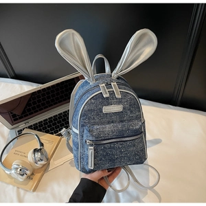 Detail of mini backpack with rabbit ears in denim blue and silver finish
