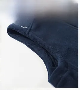 Detail of the dark blue fleece vest showing comfortable armhole design and fine stitching