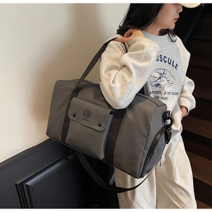Detail view of large grey fitness bag with waterproof fabric and metal buckle front pocket