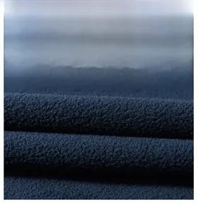 Close-up detail of thick navy blue polar fleece fabric showing soft textured grain