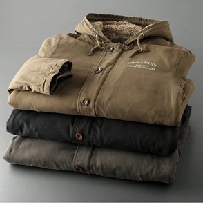 Detailed macro view of heavy canvas workwear jackets with warm faux lamb wool lining and embroidery