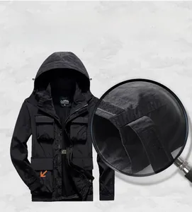 Detail view of adjustable velcro cuffs on a black waterproof outdoor hooded jacket
