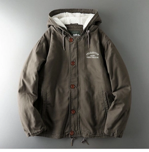 Detail of dark brown workwear jacket showing white sherpa lining and wooden buttons