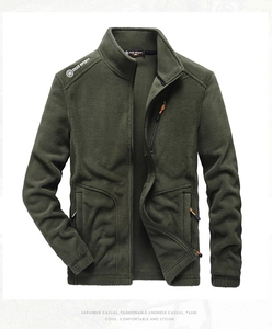 Close-up of army green fleece jacket featuring Free Spirit embroidery and orange zippers