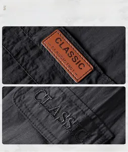 Detail of premium leather patch and classic embroidery on waterproof outdoor jacket