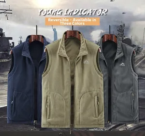 Close-up of three reversible fleece vests in navy, khaki and grey with outdoor chest logo