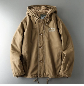 Detail of tan workwear jacket featuring thick sherpa lining and drawstring hood design