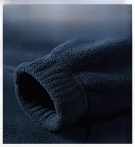 Detail of elastic ribbed cuffs on a thick dark blue fleece jacket for men