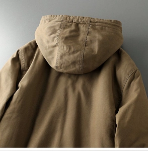 Detail view of khaki cotton workwear jacket back showing premium fabric texture