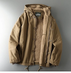 Detailed view of men's khaki winter jacket with thick sherpa lining and brand inner label