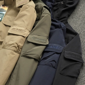 Detail showing classic embroidery and utility arm pockets on multiple outdoor jackets