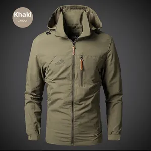 Detail of khaki outdoor jacket showing mountain embroidery and hidden chest zipper pocket