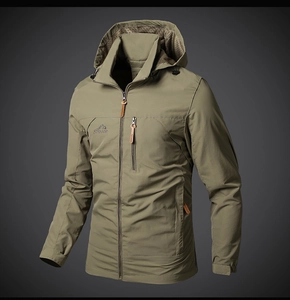 Close-up of olive green outdoor jacket with peak embroidery and waterproof zippers