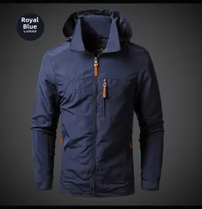 Close-up of royal blue outdoor jacket featuring embroidered logo and orange zipper detail