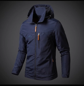 Detail of navy blue outdoor jacket showing chest embroidery and contrast zipper puller