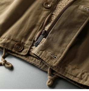 Detail of canvas workwear jacket featuring warm sherpa fleece lining and metal zipper