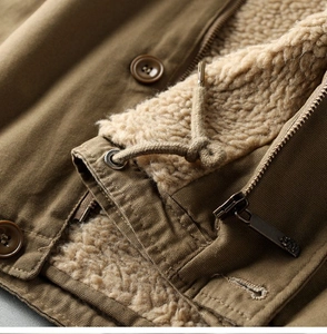 Detail of khaki canvas winter jacket with warm thick sherpa lining and metal zipper