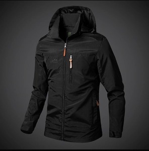 Detail view of water-resistant black outdoor jacket with adjustable hood and zipper pockets