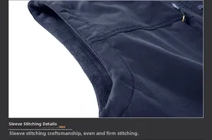 Detailed close-up of double-stitched armhole on blue fleece vest with gray inner lining