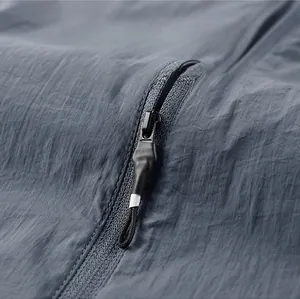 Detailed macro view of matte black zipper and high-quality gray functional fabric texture