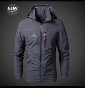 Detail of grey outdoor jacket featuring chest zip pocket and mountain logo print