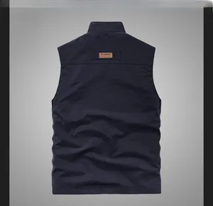 Rear view detail of a men's utility vest showing functional fabric and leather back label