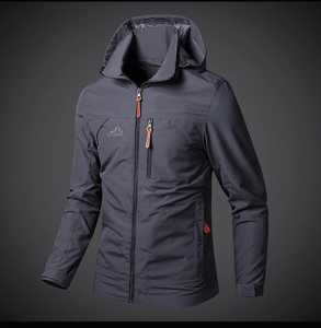 Detail of dark grey windproof outdoor jacket with zipper pocket and outdoor lettering