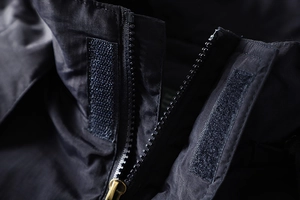 Macro shot of outdoor jacket front closure with zipper and durable velcro system
