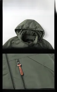 Close-up of hood with breathable mesh lining and zipper with leather pull on green jacket