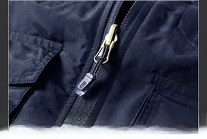 Detail of durable vintage gold metal zipper on black double-sided fleece vest for men