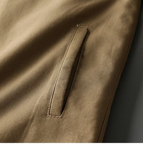Detailed view of heavy-duty cotton twill fabric and reinforced pocket stitching on jacket
