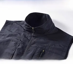 Macro detail of windproof stand collar and zipper on black outdoor utility vest