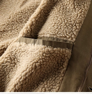 Detail of warm lamb wool lining and durable olive canvas fabric on winter work jacket