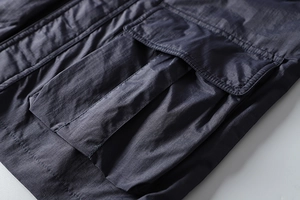 Detail shot of the large functional cargo pocket on a water-resistant tactical jacket