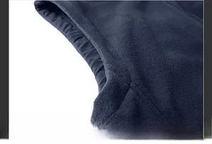 Detail of armhole stitching on dark blue fleece vest with smooth and even seams