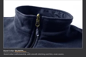 Detail of navy polar fleece vest with standing collar, metal zipper, and clean stitching