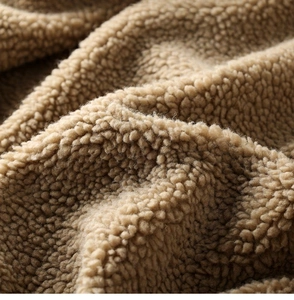 Close-up of premium khaki sherpa fleece texture with soft curly wool fibers for winter coats