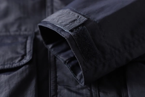 Detail of adjustable velcro cuff and durable fabric texture on outdoor jacket