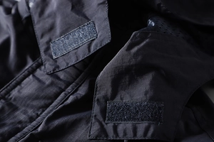 Detail of waterproof ripstop fabric with velcro collar and breathable mesh lining