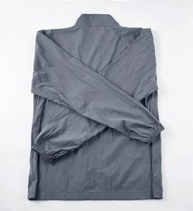 Detail of dark grey sun protection jacket with stand collar and elastic cuffs flat lay