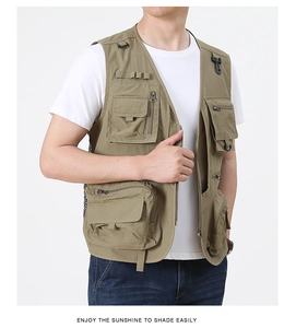 Close-up of khaki outdoor utility vest with multiple zipper pockets and D-ring detail