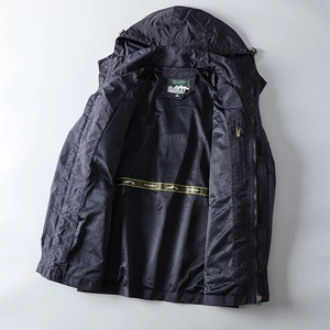 Detail of outdoor jacket showing breathable black mesh lining and yellow decorative tape