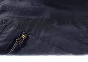 Detail of navy outdoor vest showing 'WEAR' embroidery and premium metal zipper design