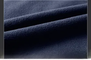 Detailed close-up showing the soft fiber structure of navy blue polar fleece fabric