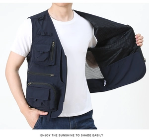 Close-up of tactical navy blue vest showing multi-pocket design and breathable mesh lining