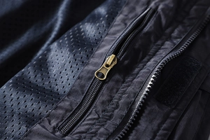 Detail of durable gold metal zipper and breathable mesh fabric on outdoor jacket